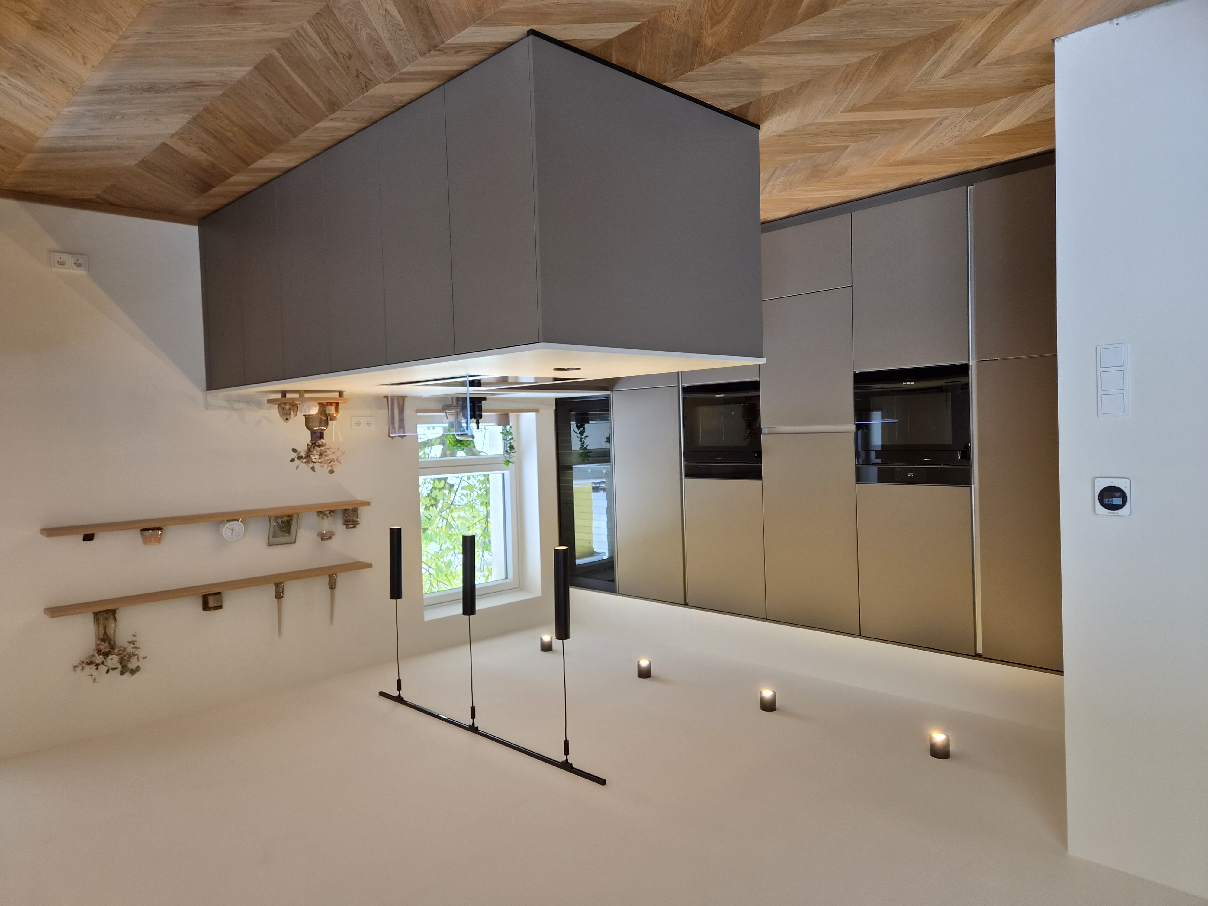 Küche mit Fischgrät-Decke und grauen Fronten